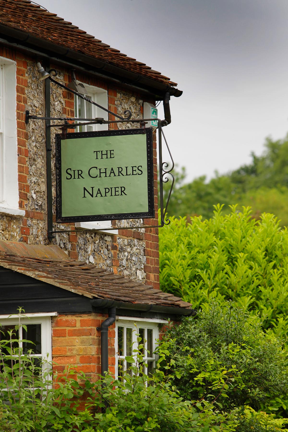 Exterior of The Sir Charles Napier with close up of sign